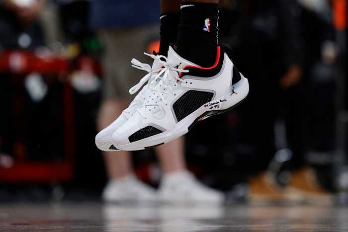 View of Bam Adebayo's white, black, and red Air Jordan shoes.